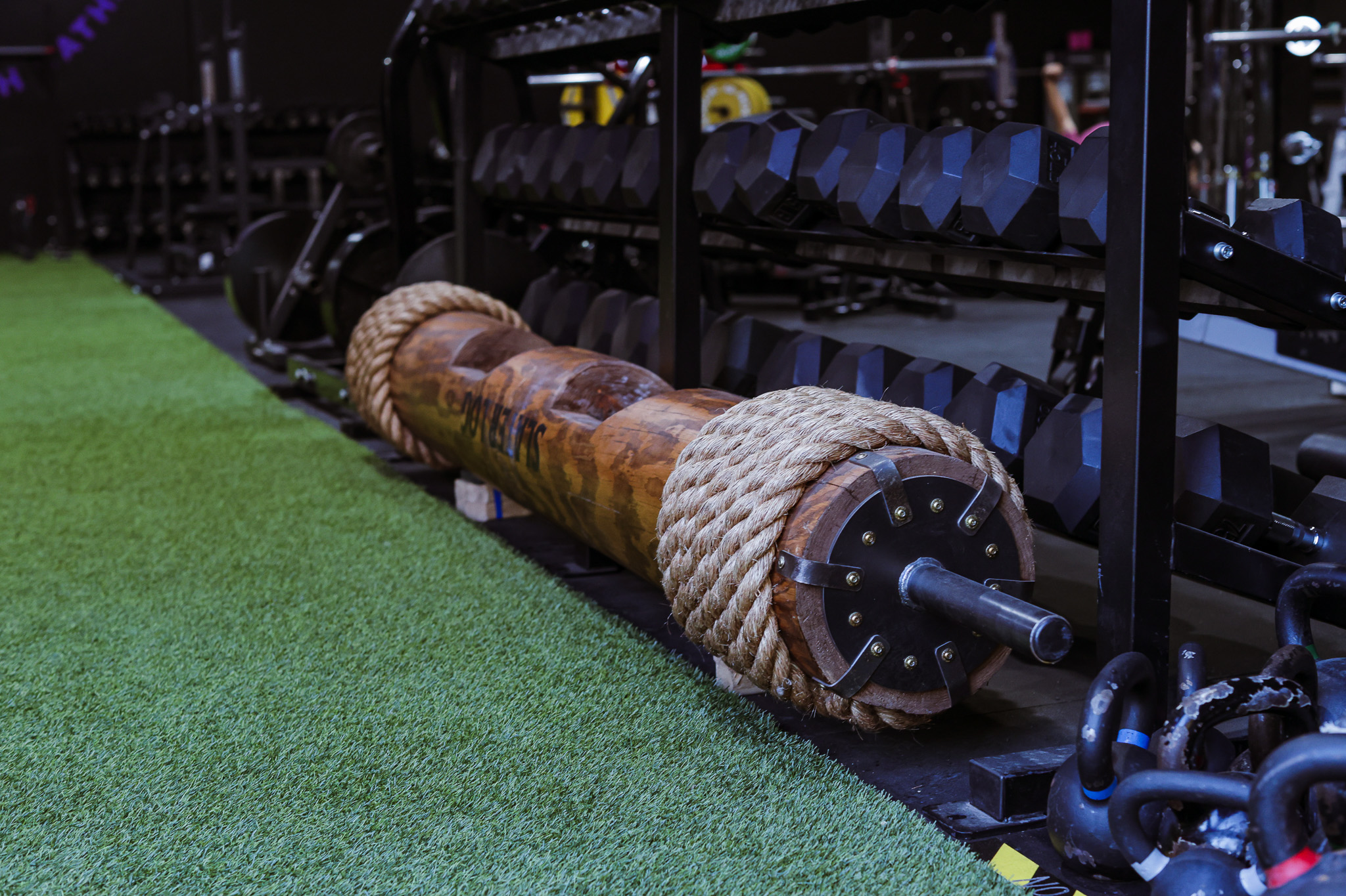 Atlas stones, yokes, and strongman implements on the turf strip